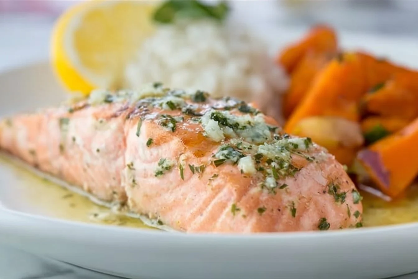 Deliciously baked salmon fillet garnished with herbs and lemon slices